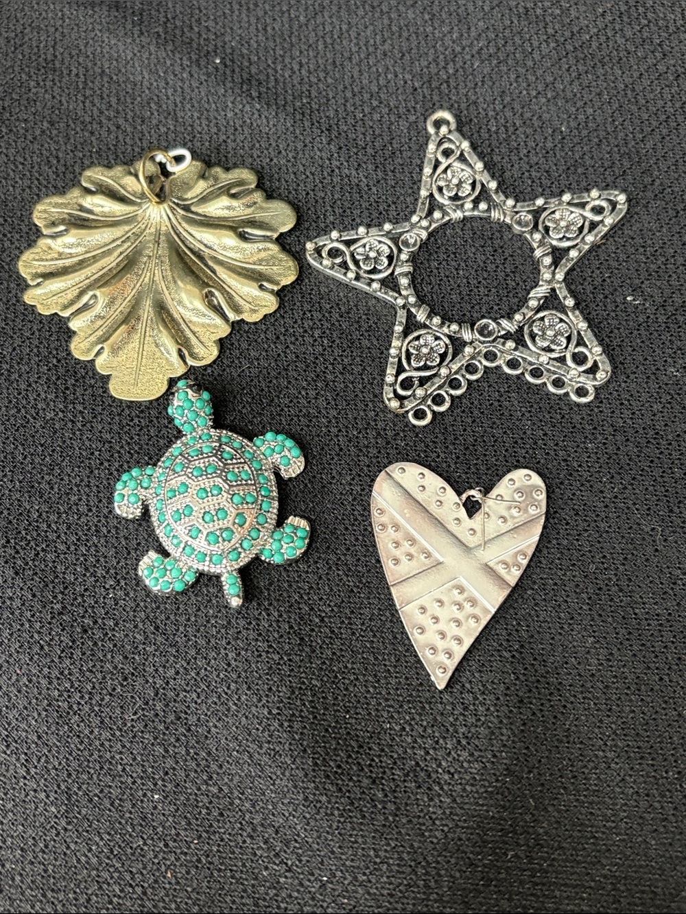 4 necklace pendants:  Gold Leaf, Silver Star, Turquoise Turtle, & Silver Heart